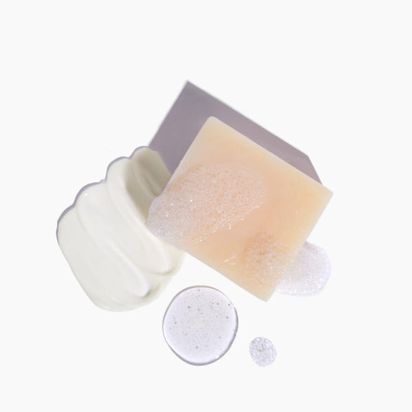 Detailed texture shot of Heliotrope massage candle and soap included in the Discovery Kit
