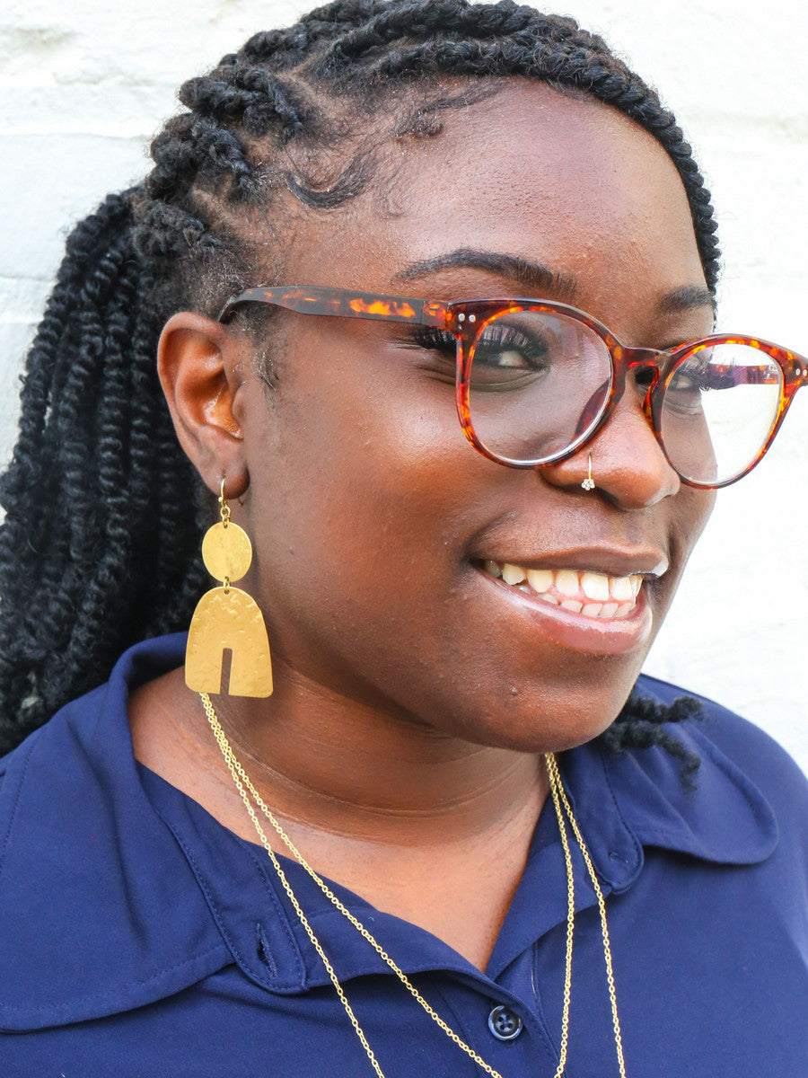 Model wearing Fair Anita statement geometric arch earrings, nickel-free dangle earrings styled casually