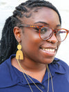 Model wearing Fair Anita statement geometric arch earrings, nickel-free dangle earrings styled casually