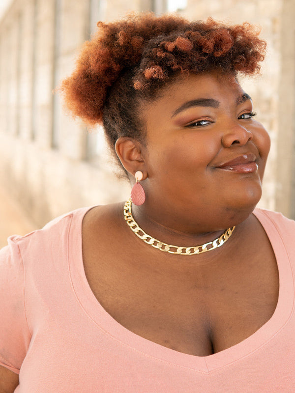 Close-up of sustainable peach drop earrings made from upcycled animal bone by Fair Anita