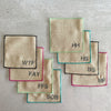 Sweary cocktail coasters set of 8 by Dot and Army styled on a bar cart, showing full set with colorful borders and playful letter designs