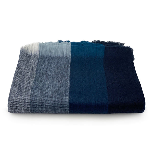Folded blue and gray blanket on a white background