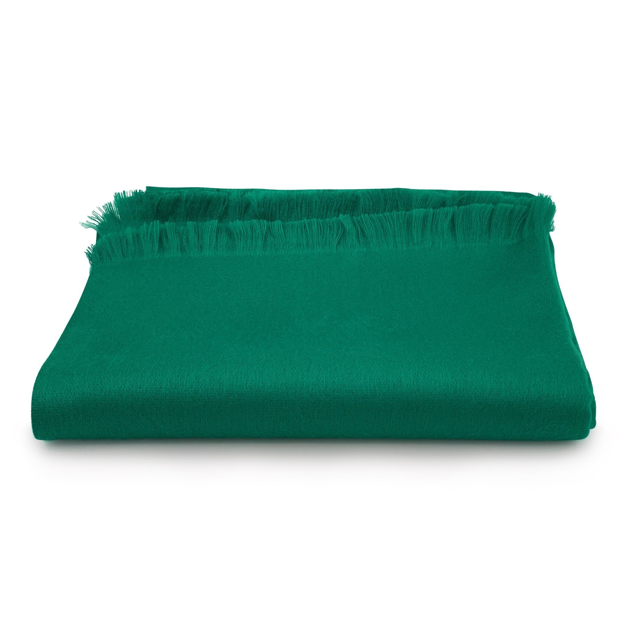 Green blanket with frayed edges on a white background