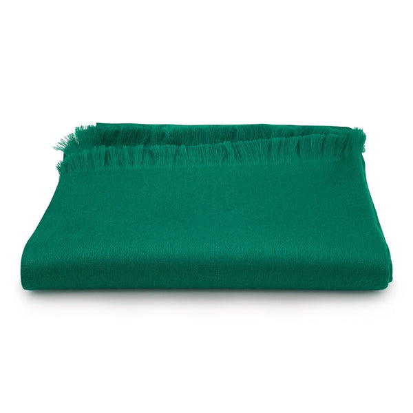 Green blanket with frayed edges on a white background