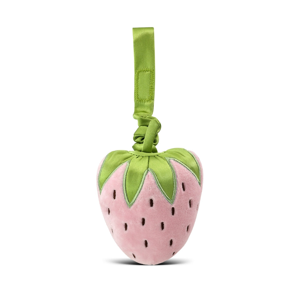 Pink strawberry-shaped toy with green leaves on a white background