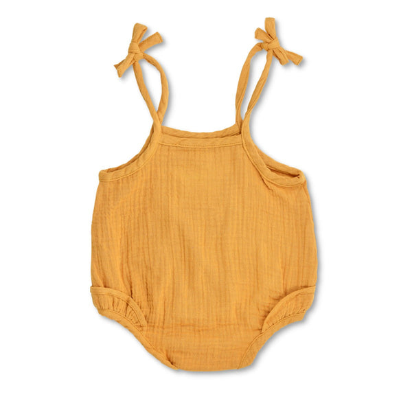 Mustard organic muslin ruffle romper with adjustable spaghetti tie straps and snap bottom closure for babies