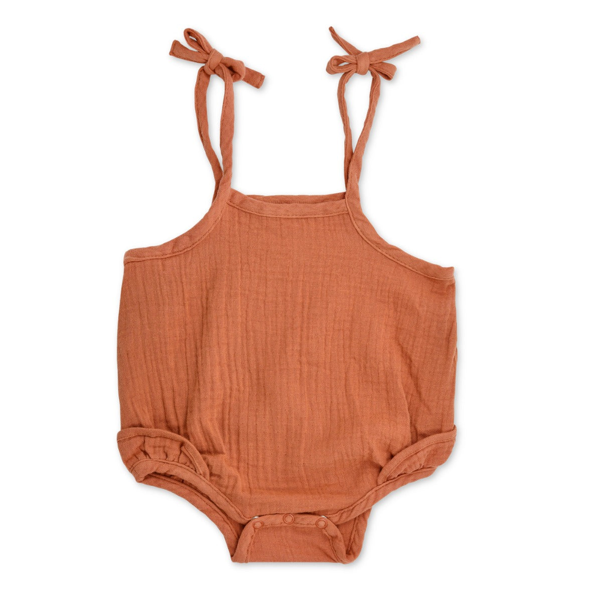 Rust-coloured organic muslin ruffle romper with adjustable spaghetti tie straps and ruffle leg detail by Apple Park & Organic Farm Buddies