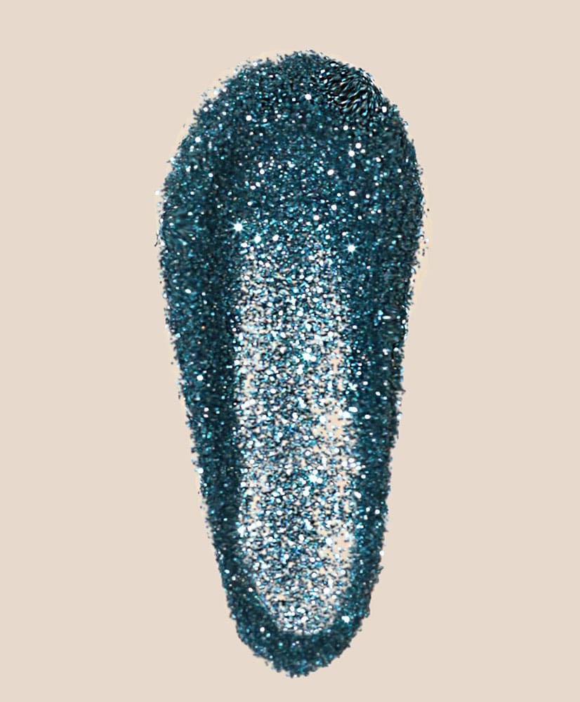 Blue glittery object on a beige background