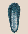Blue glittery object on a beige background
