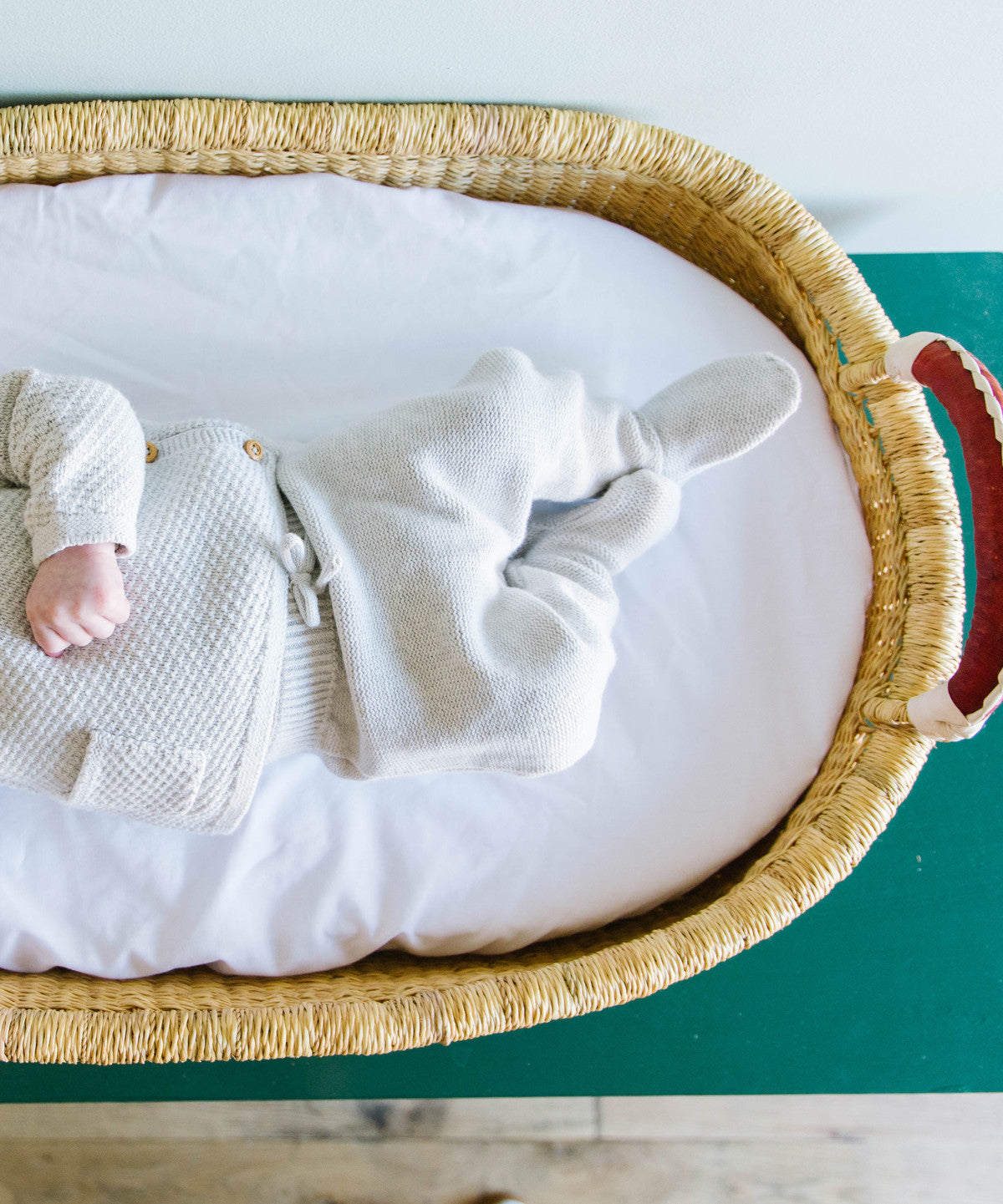 Top view of Meadow Changing Basket showing natural elephant grass weave and hand-dyed navy pattern for baby nursery
