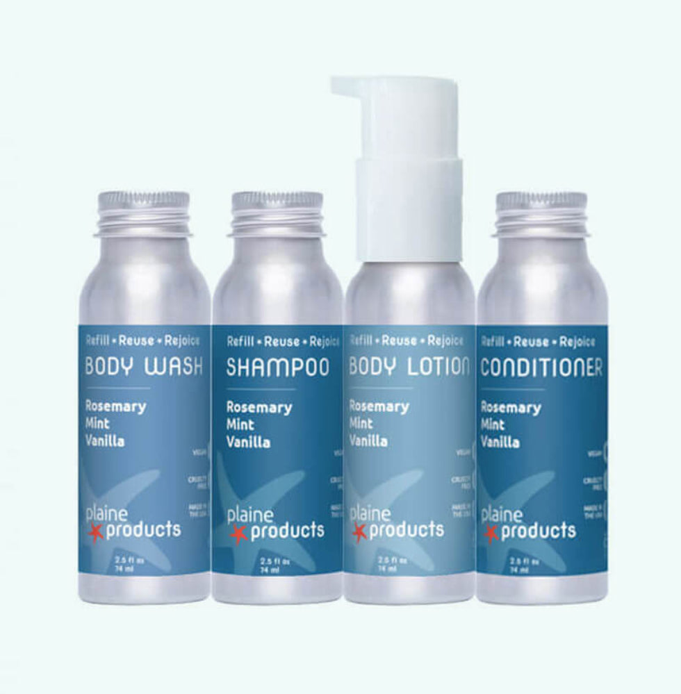 Plaine Products reusable travel set in Rosemary Mint Vanilla – shampoo, conditioner, body wash and lotion in aluminum bottles