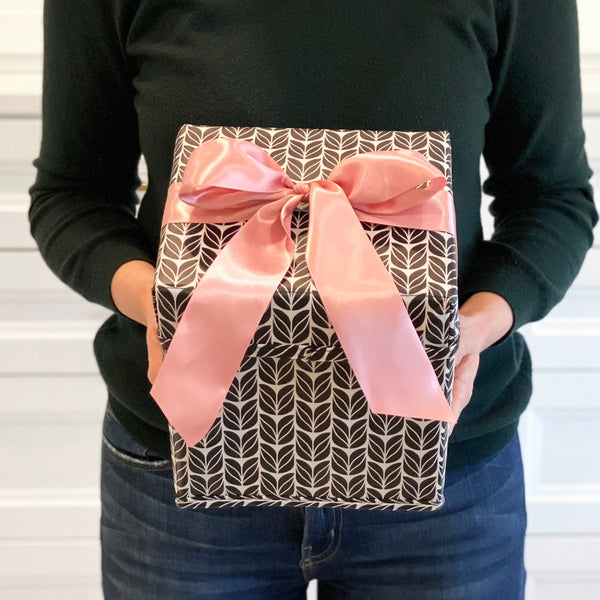 EverBox folded flat for storage — compact collapsible gift box in black, white and pink