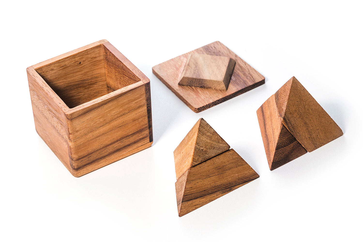 Two Pyramids In a Box wooden puzzle pieces arranged on a flat surface