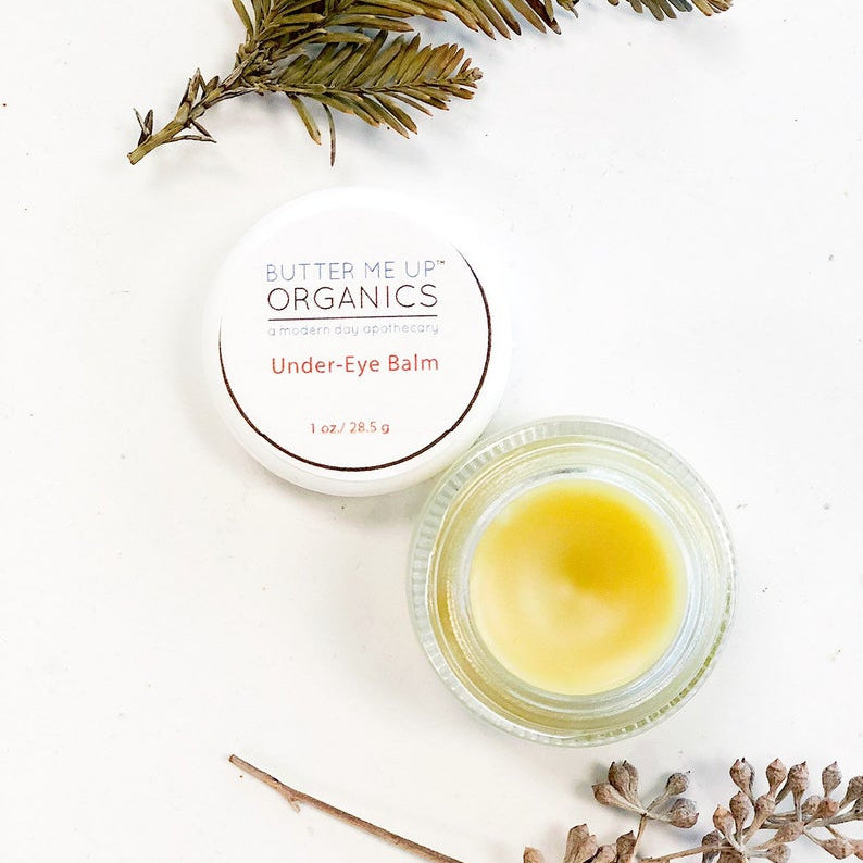 Butter Me Up Organics caffeinated under eye balm in glass jar for dark circles and puffiness