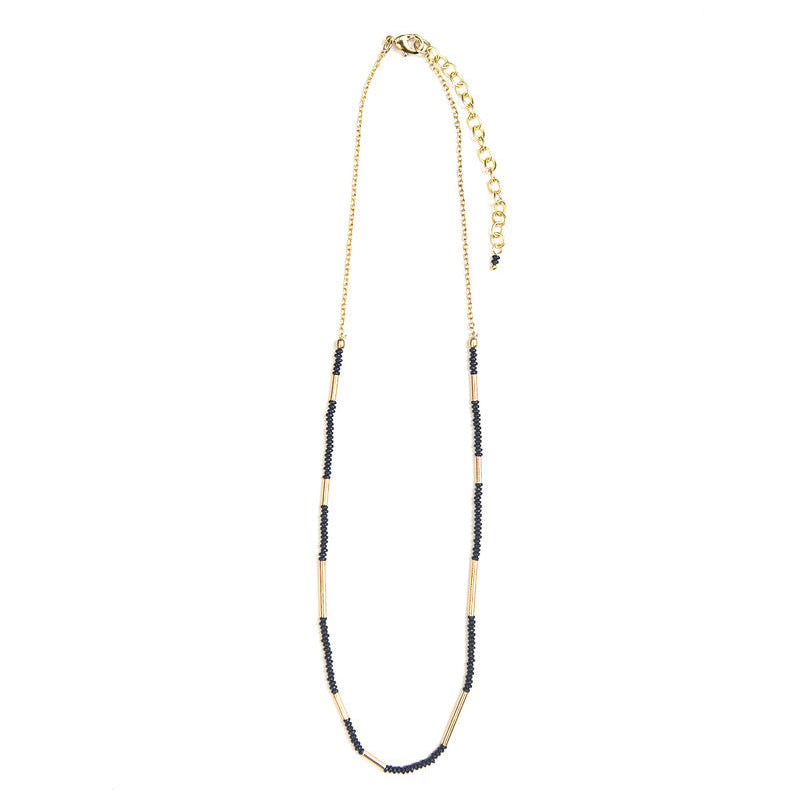 Fair trade Morse Code Necklace with natural black beads and brass accents worn as a layering necklace