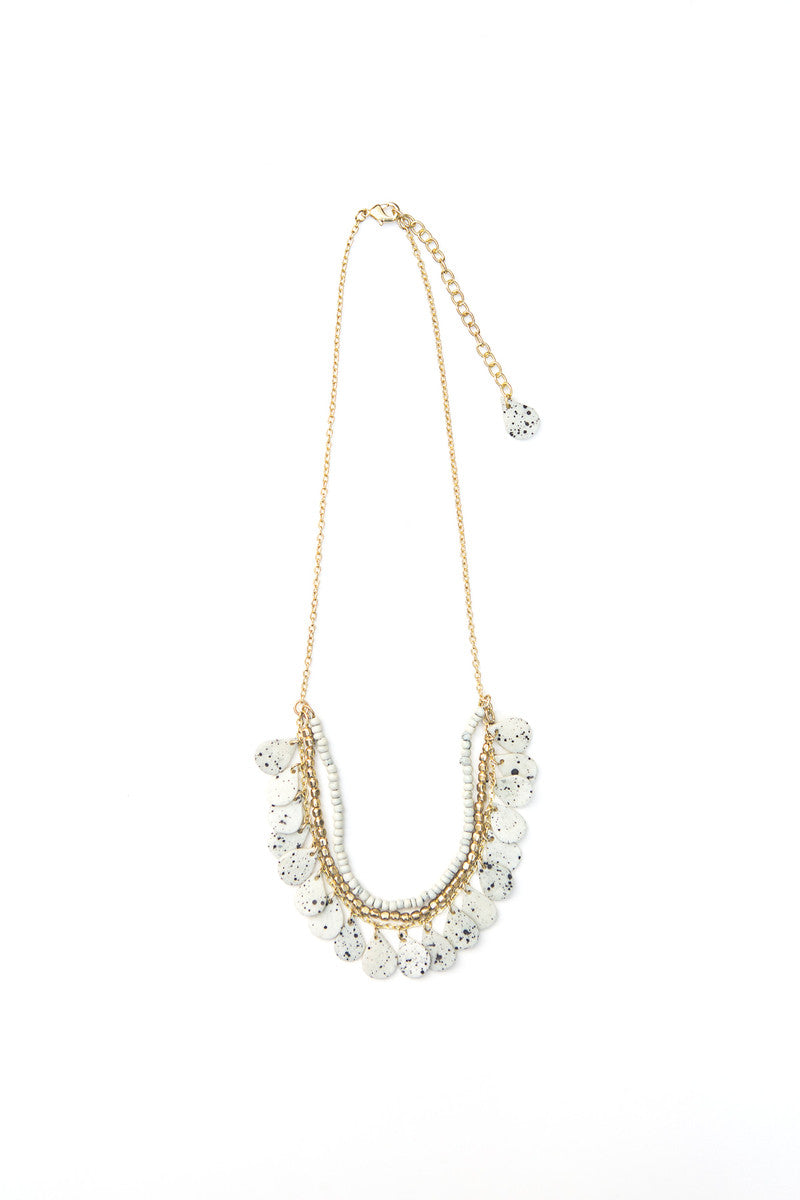 Fair trade speckled bone necklace worn as a styled accessory, made by women artisans in India