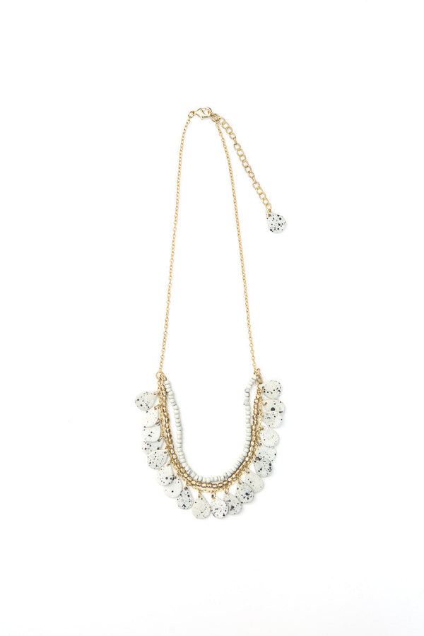 Fair trade speckled bone necklace worn as a styled accessory, made by women artisans in India