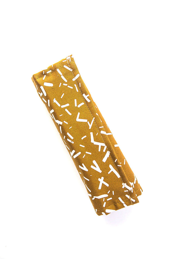 Wayfarer Jewelry Roll unrolled and open showing earring storage, zipped pouches and necklace loops in Confetti Mustard