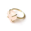 Rose quartz pronged ring with oversized natural stone in brass prong setting on white background
