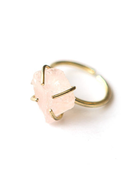 Close-up of rose quartz pronged adjustable ring showing natural stone texture and brass prong setting