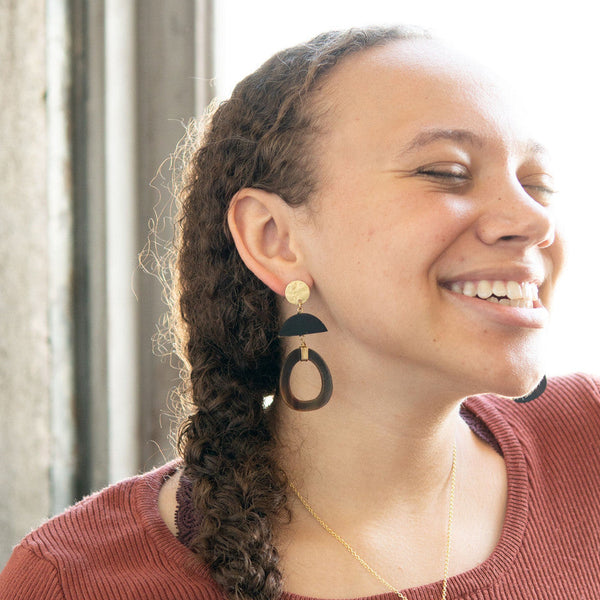Close-up of Fair Anita upcycled horn oval earrings showing natural texture and gold findings
