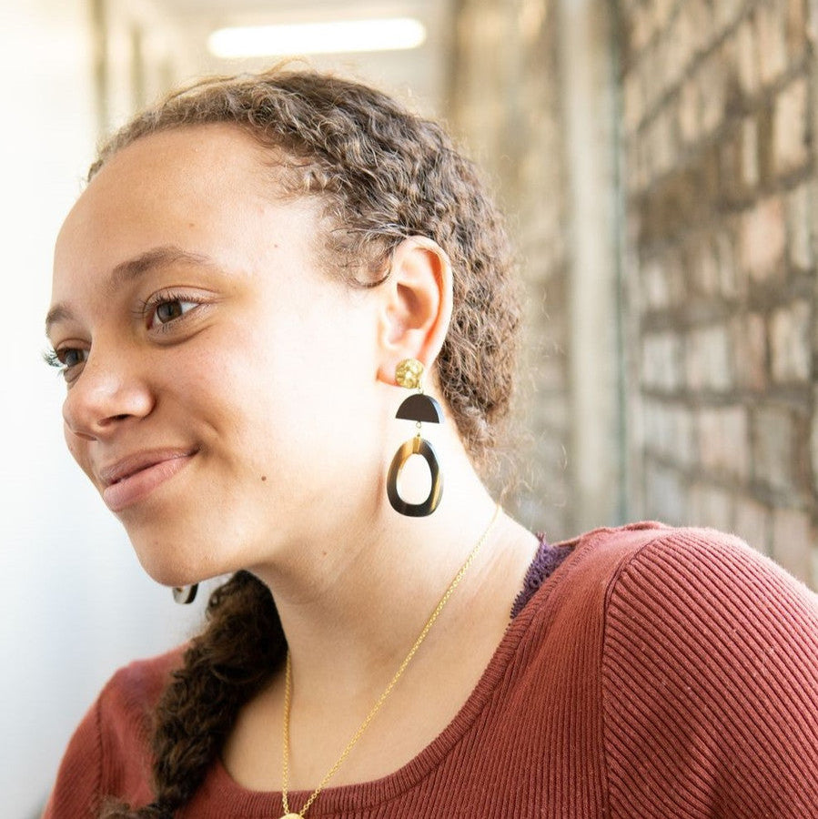 Fair Anita upcycled horn statement earrings displayed flat, showing oval shape and warm tones