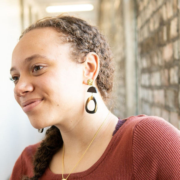 Fair Anita upcycled horn statement earrings displayed flat, showing oval shape and warm tones