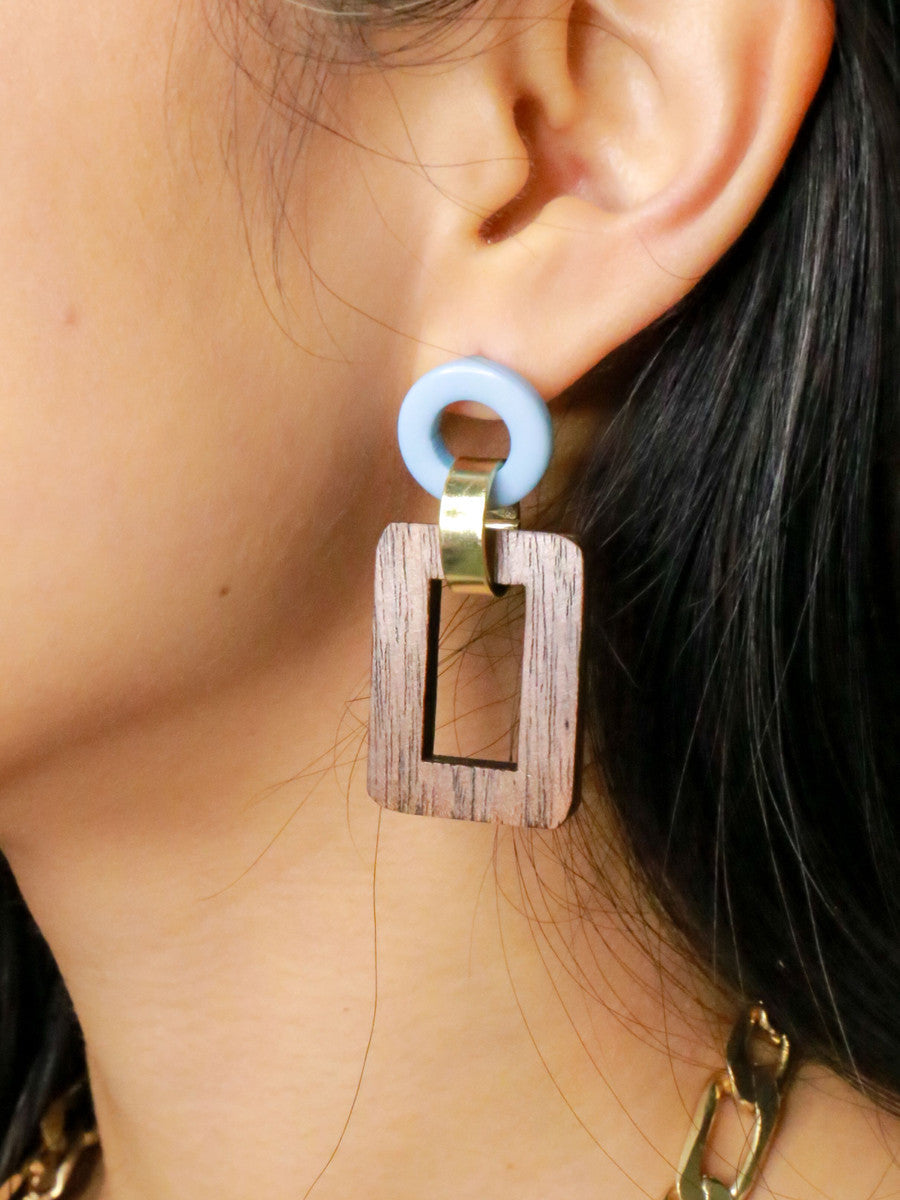 Close-up of upcycled wood open rectangle drop earrings with blue resin stud by Fair Anita