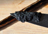 Black rubber tire tread on a wooden surface