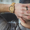 Person wearing a wooden watch with a blurred background