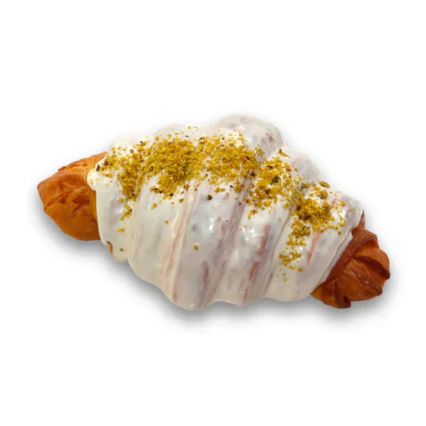 Pastry with white icing and gold sprinkles on a white background