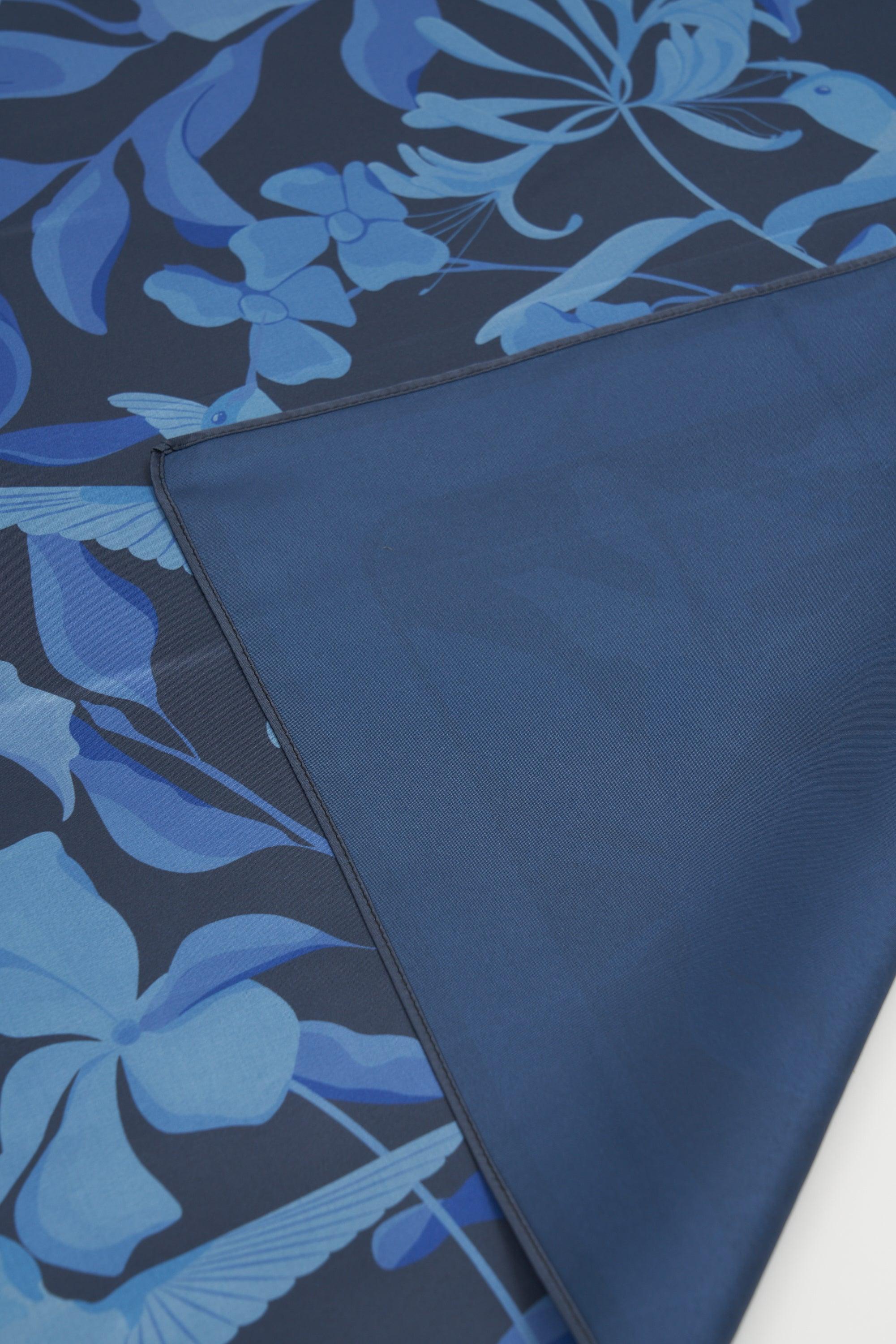 Blue floral patterned fabric with a plain blue section