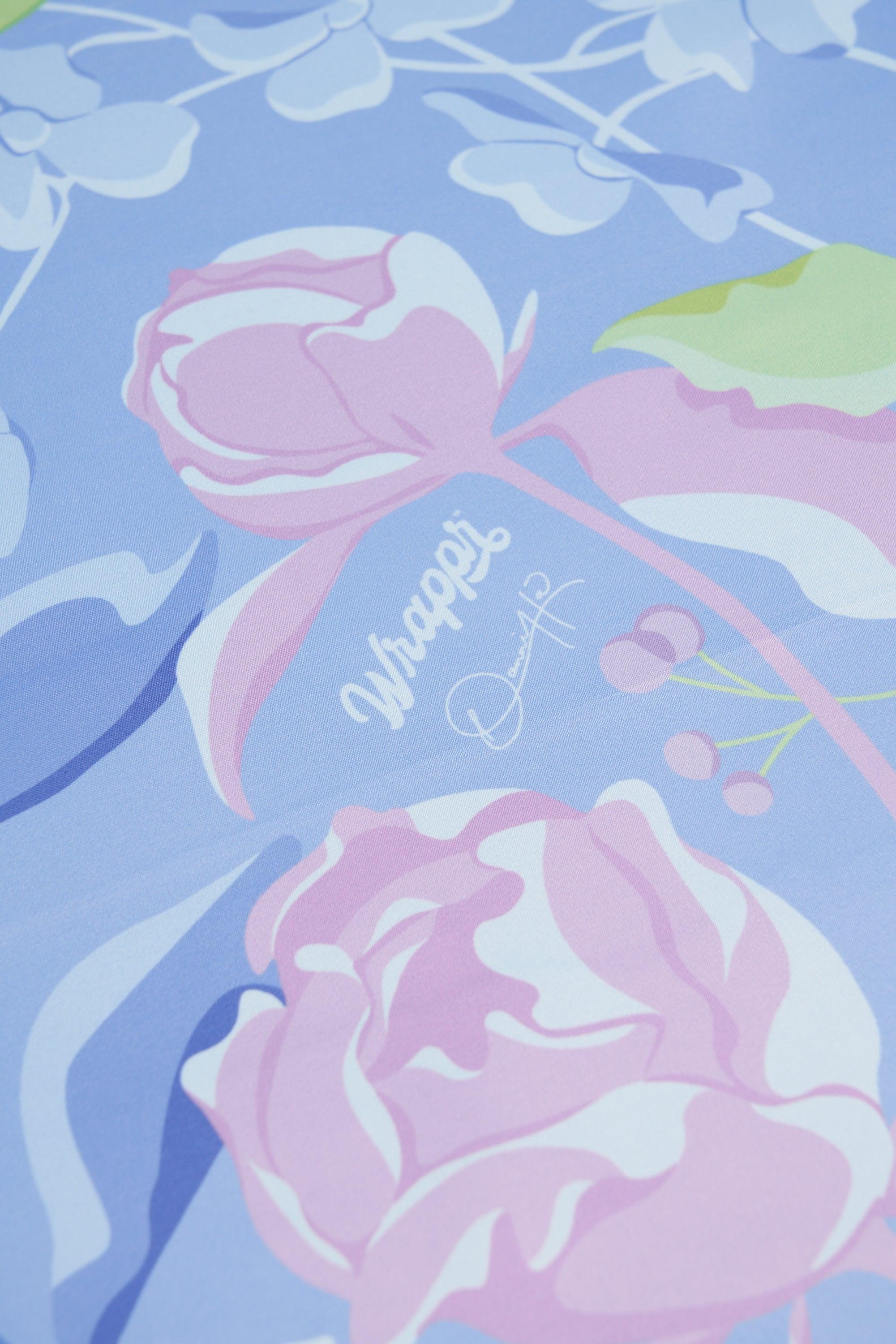 Floral design with pink roses on a blue background, featuring the brand 'Wraps'.