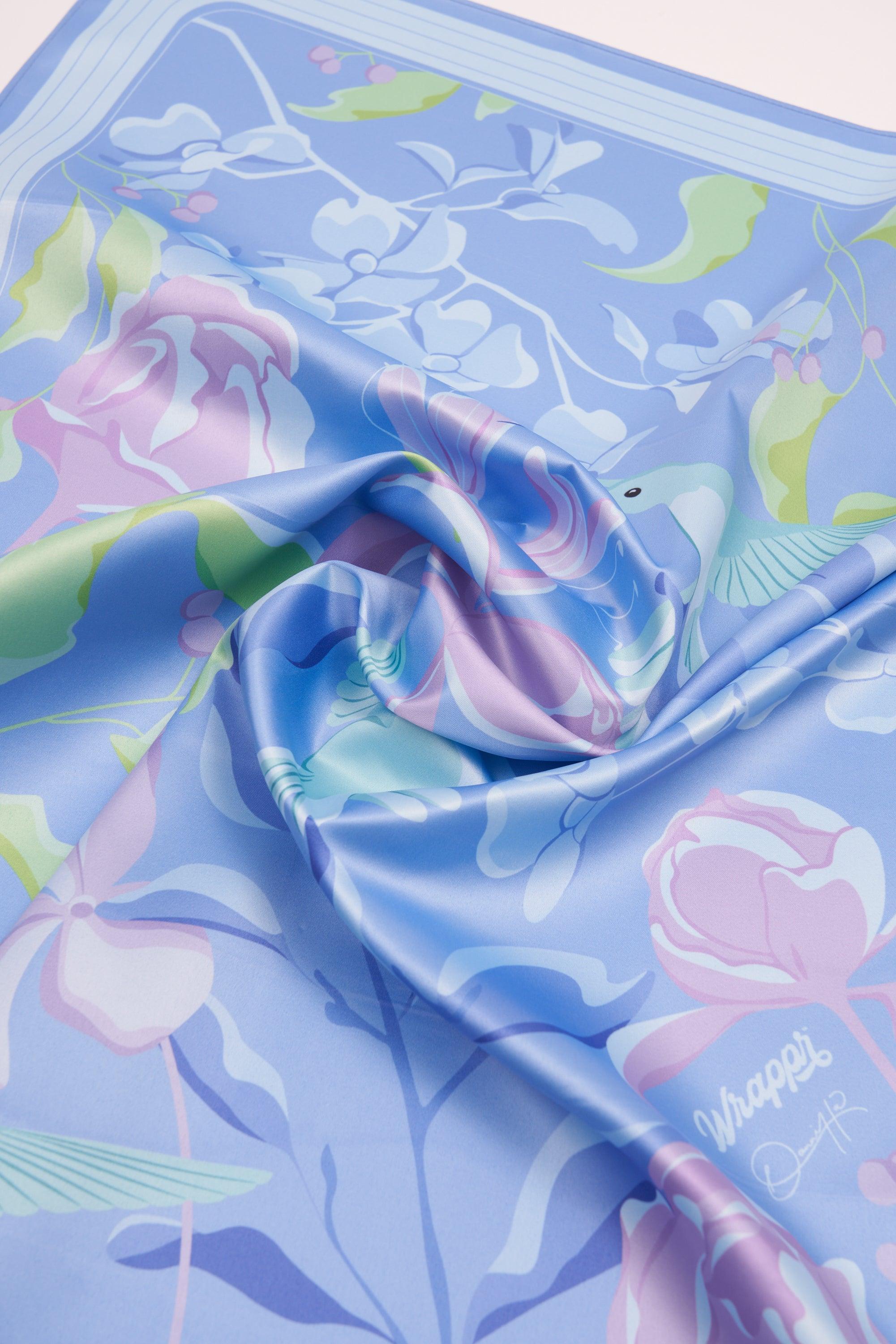 Floral-patterned fabric with pink roses and green leaves on a blue background