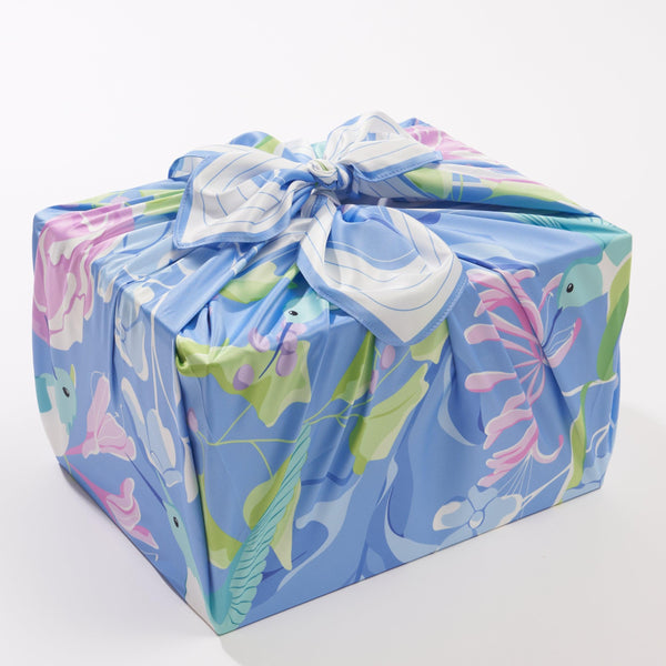 Gift wrapped in colorful paper with a bow on a white background