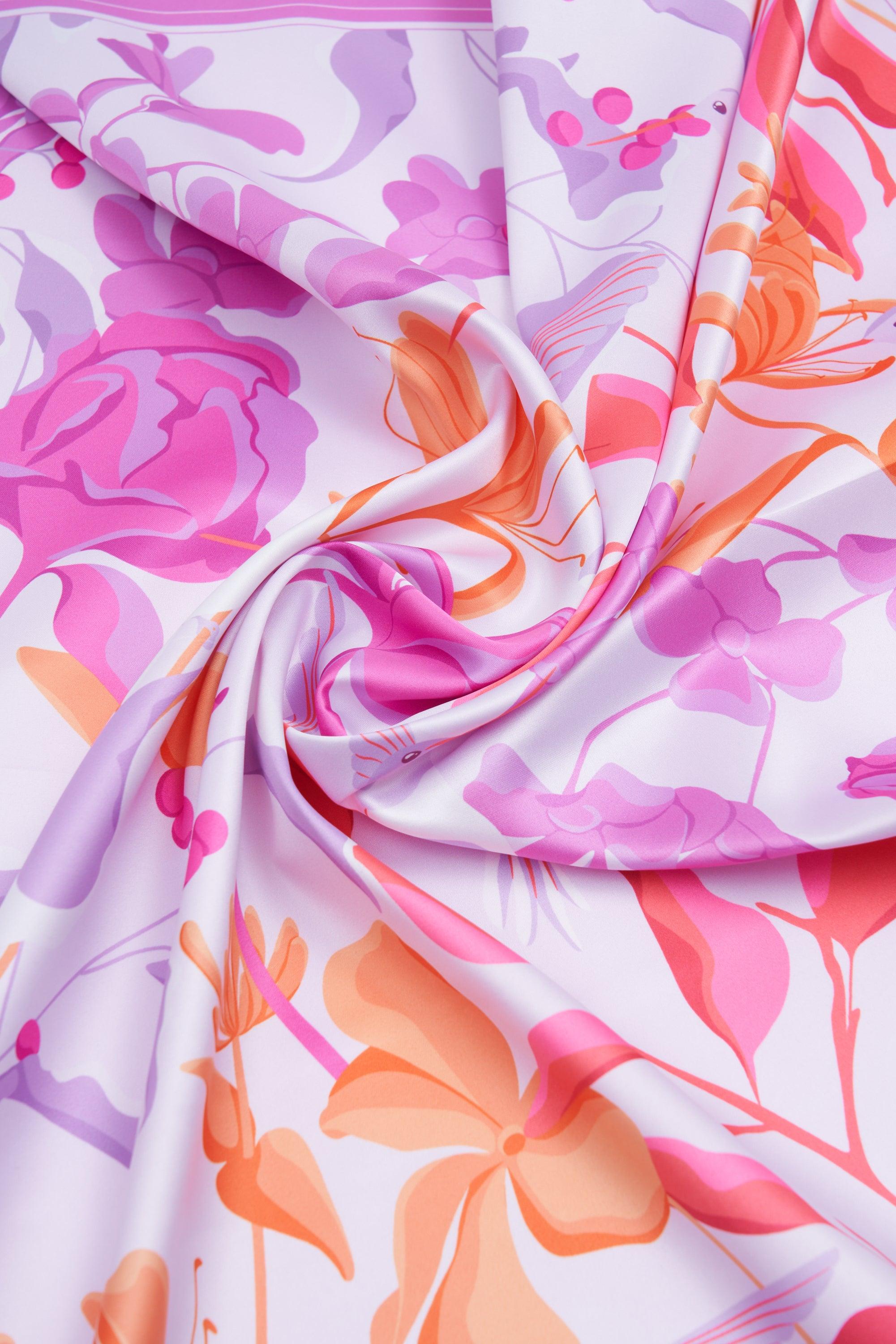 Colorful floral fabric with pink, orange, and purple flowers on a white background