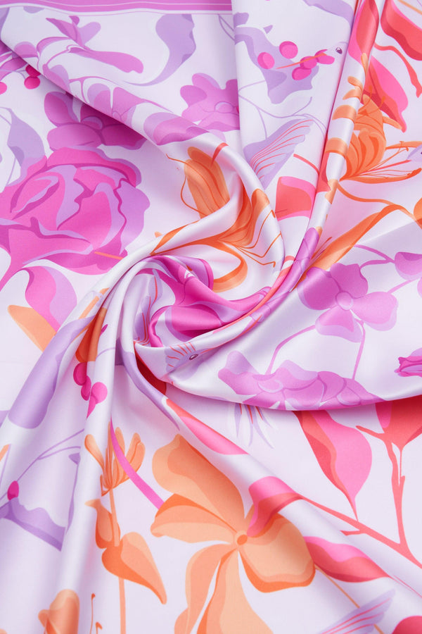 Colorful floral fabric with pink, orange, and purple flowers on a white background