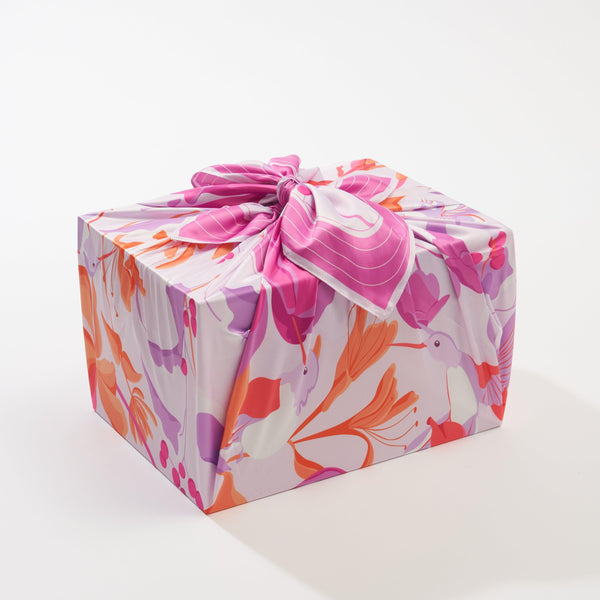 Wrappr furoshiki gift wrap by Danni Ha styled as a wrapped present, demonstrating sustainable reusable gift wrapping in use