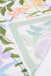 Floral and bird patterned paper with a focus on a green sheet.