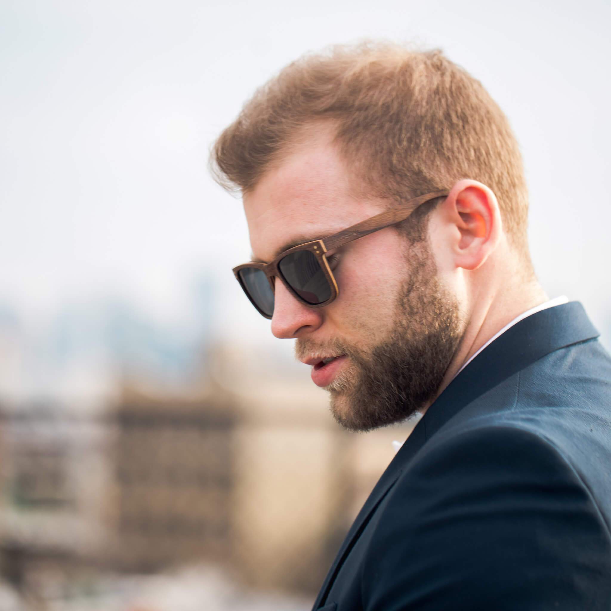 Walnut Wayfinder eco-friendly wooden sunglasses by Joycoast, side profile showing walnut grain detail