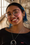 Fair Anita wavy silver hoop earrings styled with a silver ring necklace, fair trade jewellery made from recycled brass