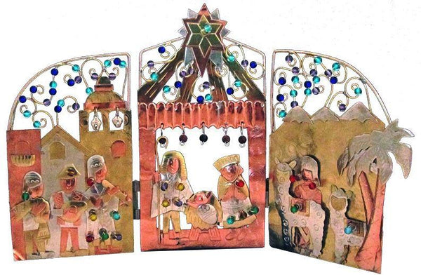 Three-dimensional nativity scene with colorful figures and architecture on a white background