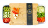Bamboo cutting board with vegetables on a white background