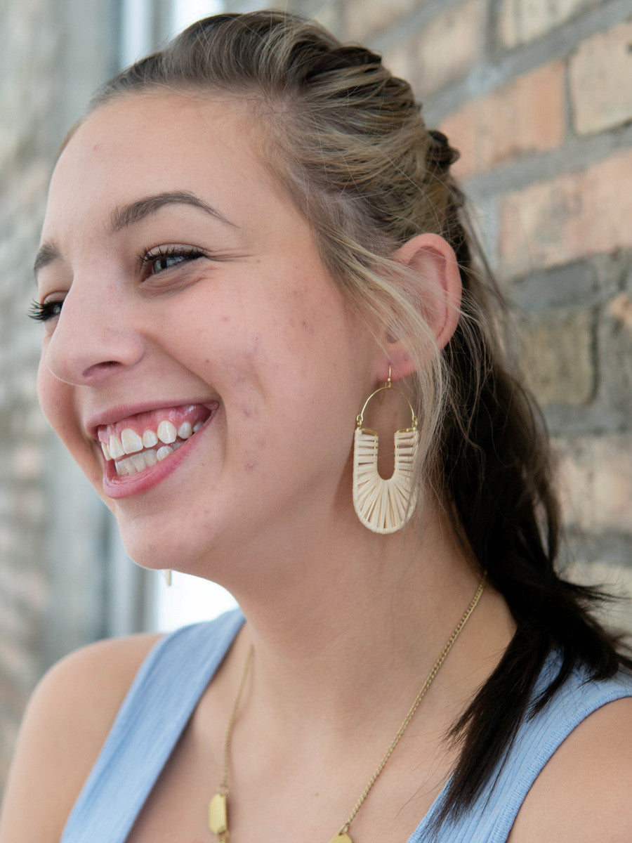 Fair Anita white woven hoop earrings styled on model – natural raffia statement earrings