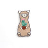 Embroidered patch of a llama holding a cactus on a white background