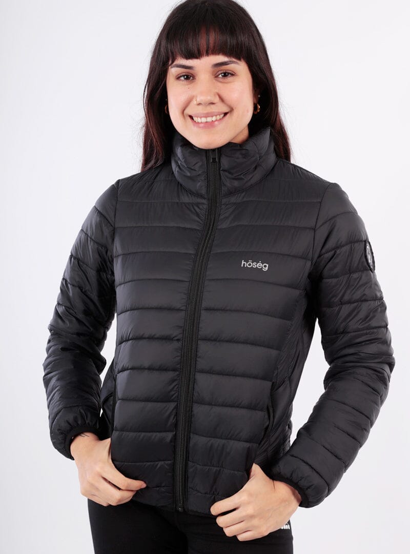 Woman wearing a black puffer jacket with 'hoseg' branding on a white background