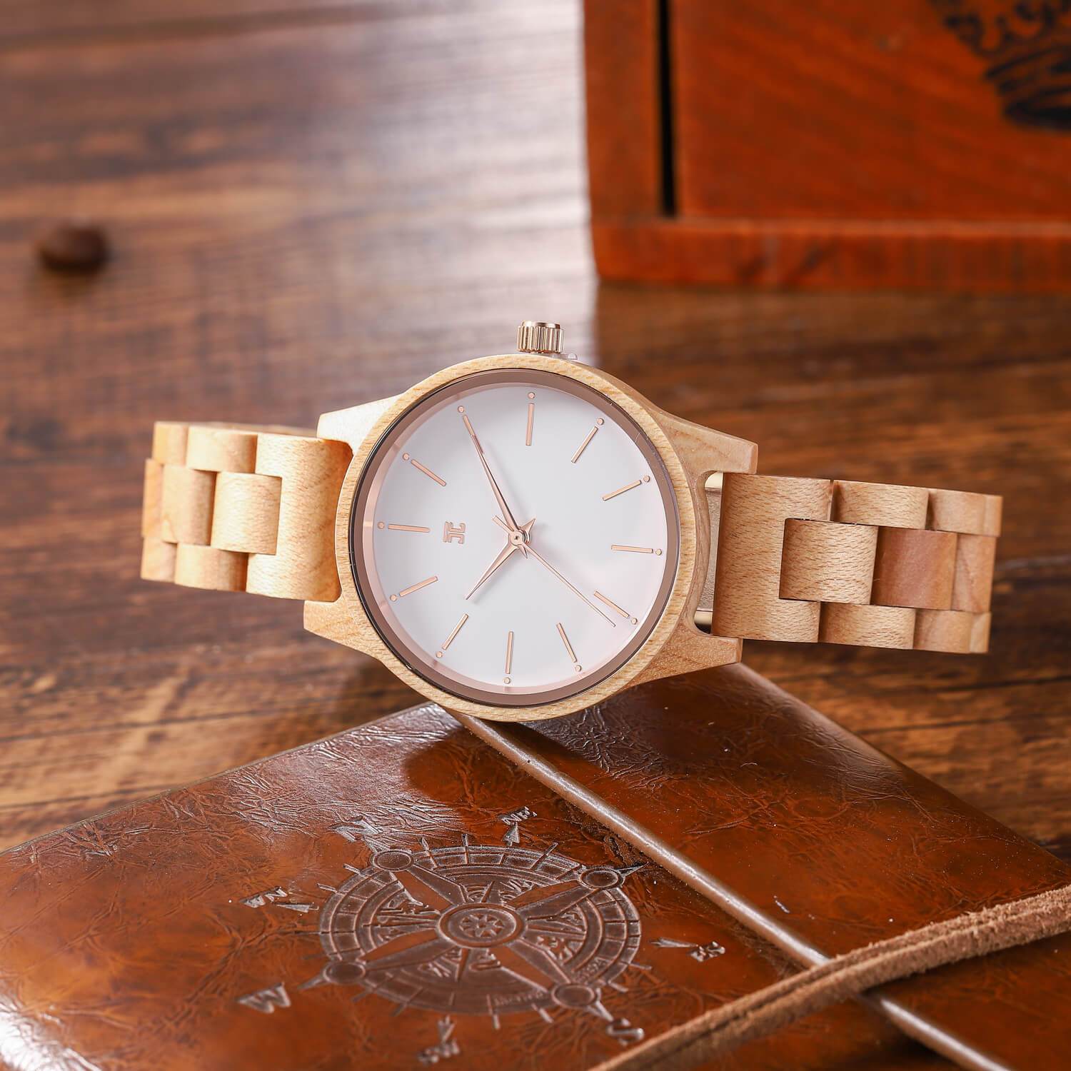 Wooden watch with a white face on a brown leather surface