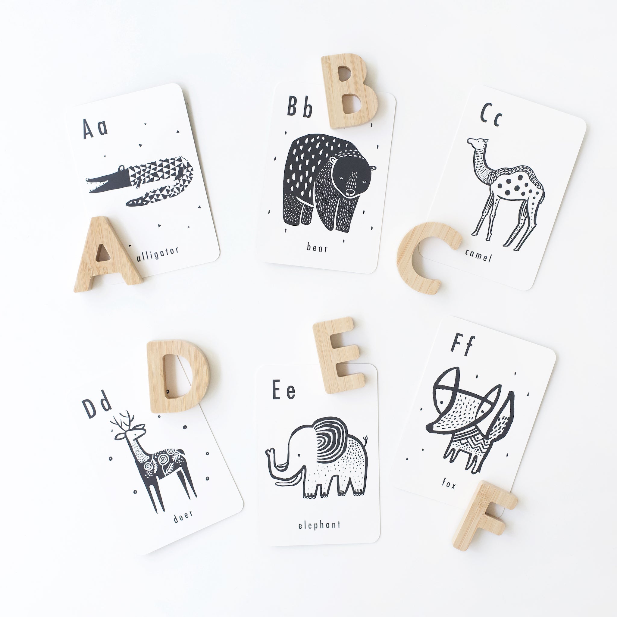 Wooden alphabet letters displayed alongside Wee Gallery Animal Alphabet Cards for toddler learning