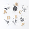 Wooden alphabet letters displayed alongside Wee Gallery Animal Alphabet Cards for toddler learning