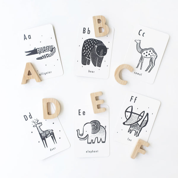 Wooden alphabet letters displayed alongside Wee Gallery Animal Alphabet Cards for toddler learning
